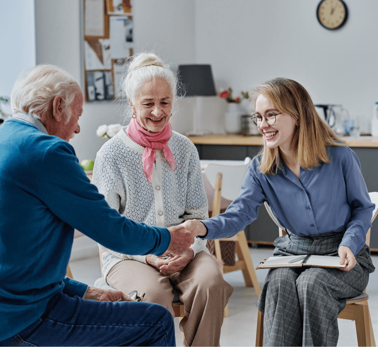 Elderly couple meeting with a young woman.