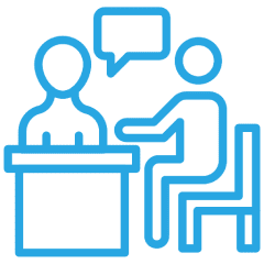 Two figures discussing at a table icon.